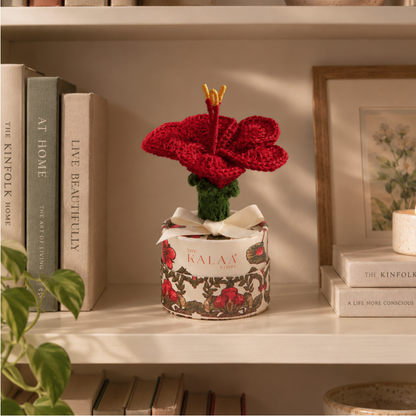Close-up of the hibiscus crochet flower showing its handmade yarn petals and texture
